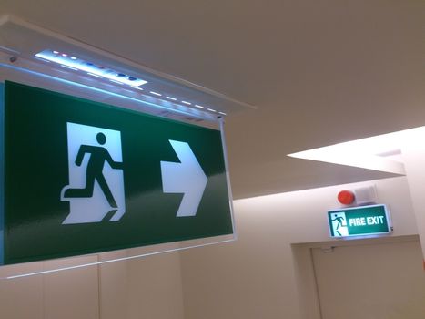 Emergency exit sign in building (fire exit)