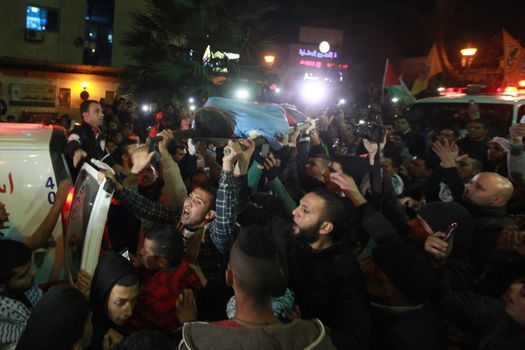 WEST BANK, Bethlehem : Palestinians carry the body of 16-year-old Mamoon Raed Muhammed al-Khatib,and the body of Essam Thawabteh,two young alleged Palestinians attackers whose bodies were held by Israeli forces, in Bethlehem on December 27, 2015. Since a wave of unrest swept the occupied Palestinian territory at the beginning of October 2015, Israel has routinely held the bodies of Palestinians it alleges were attempting to attack Israelis when they were killed. Israel turned over to the Palestinian Authority the bodies of seven alleged Palestinians attackers on December 26, 2015. 