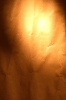 Crumpled paper background with beam of light