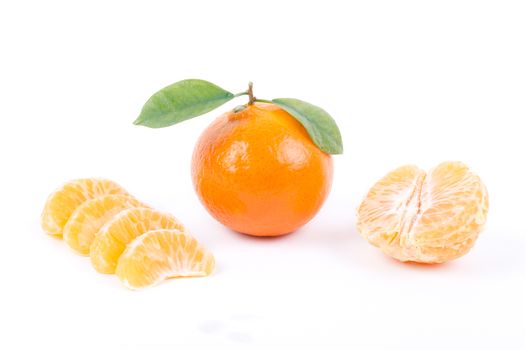 Tangerine with leaves and slices on white background