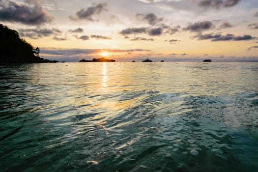 Beautiful landscape morning sky over the sea and beach at Honeymoon Bay during sunrise is a famous attractions for diving on Miang island in Mu Koh Similan National Park, Phang Nga Province, Thailand