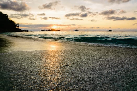 Beautiful landscape morning sky over the sea and beach at Honeymoon Bay during sunrise is a famous attractions for diving on Miang island in Mu Koh Similan National Park, Phang Nga Province, Thailand