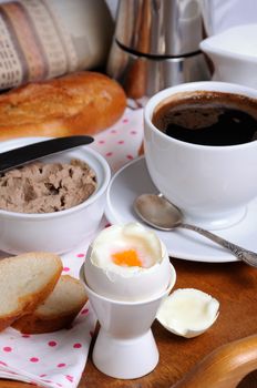 Eggs boiled in pashotnitse for breakfast with a cup of coffee and liver pate