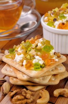 portion of cottage cheese with jam and marmalade, nuts on a cracker