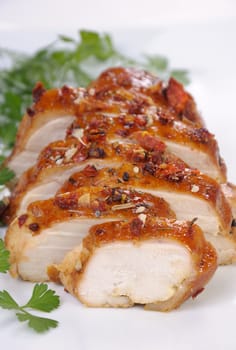 Baked chicken breast with spice sliced on a plate