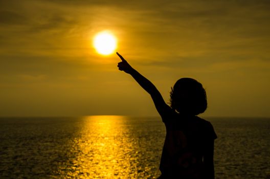 Silhouette of girl at sunset on ocean. concept hope