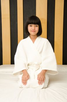 Adorable little asia girl waked up in her bed.