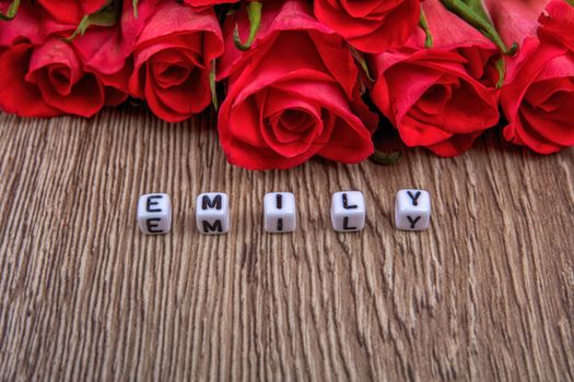 White cubes as a inscription Emily on a wooden background