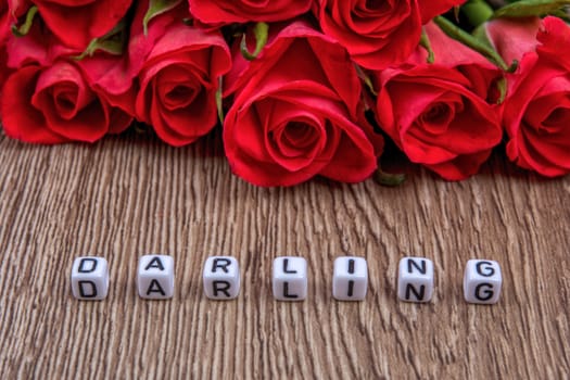 White cubes as a inscription darling on a wooden background