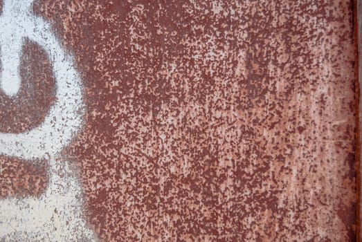 rusty iron surface covered with old chipped paint, which has long been influenced by different climatic conditions