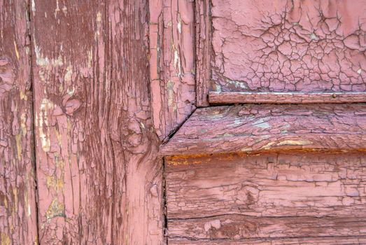 texture of wooden surface with remnants of old paint that has dried and cracked under the influence of weather