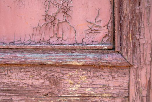 texture of wooden surface with remnants of old paint that has dried and cracked under the influence of weather