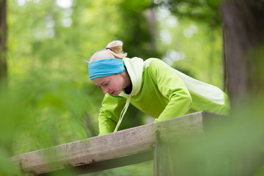 Sporty young female working out in forest.  Female runner during outdoor workout in nature. Fitness model outdoors. Weight Loss. Healthy lifestyle. 