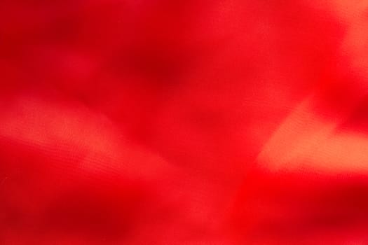 Shiny Red silky fabric folds background texture