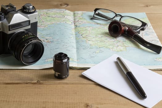 vintage camera and film on a map on the table