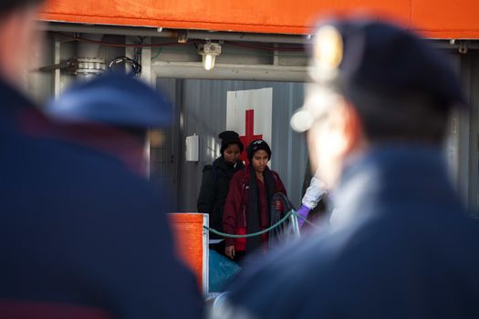 ITALY, Palermo: Migrants are seen disembarking from the military Norwegian ship Siem Pilot in Palermo on December 28, 2015. Among them 841 men, 64 women, and 26 children came from 30 different nationalities including Morocco and other Subsaharian countries. The Norwegian vessel has already rescued over 11,500 people from the Mediterranean since June.