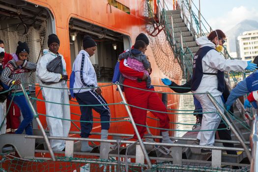 ITALY, Palermo: Migrants are seen disembarking from the military Norwegian ship Siem Pilot in Palermo on December 28, 2015. Among them 841 men, 64 women, and 26 children came from 30 different nationalities including Morocco and other Subsaharian countries. The Norwegian vessel has already rescued over 11,500 people from the Mediterranean since June.