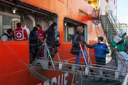 ITALY, Palermo: Migrants are seen disembarking from the military Norwegian ship Siem Pilot in Palermo on December 28, 2015. Among them 841 men, 64 women, and 26 children came from 30 different nationalities including Morocco and other Subsaharian countries. The Norwegian vessel has already rescued over 11,500 people from the Mediterranean since June.