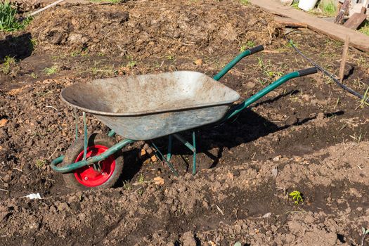 a cart for carrying  cargo in the garden in spring