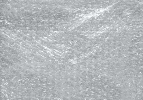 Fragment of a surface covered with multiple layers of a cling polyethylene film as a background texture