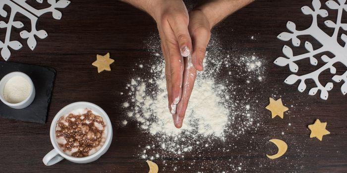 ready for dough by hands on wooden table background