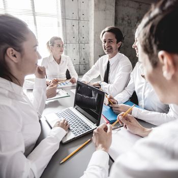 Group of business people working together at meeting in office