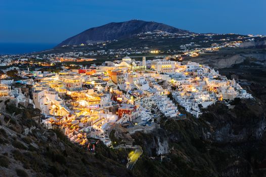 Illuminated Luxury balcony decks and patios of Fira at night, Santorini, Greece