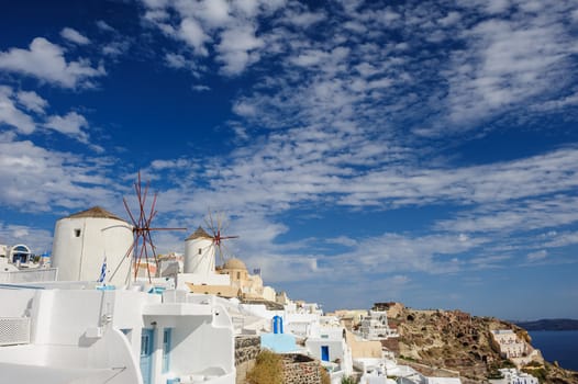 View of famous windmill in Oia village at Santorini Island, Greece. Copyspace.