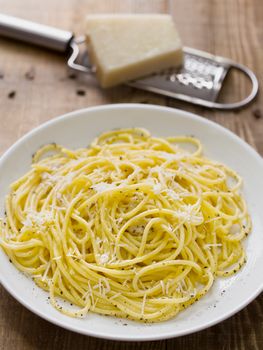 close up of rustic italian pepe e cacio pepper with cheese spaghetti