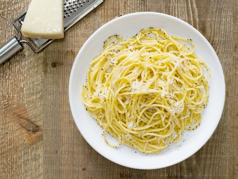 close up of rustic italian pepe e cacio pepper with cheese spaghetti