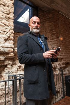 Businessman middle-aged bearded and suit jacket searching on tablet on a blurred background