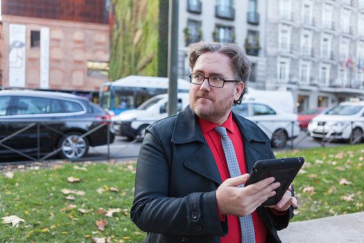 A young businessman with glasses in a urban scene