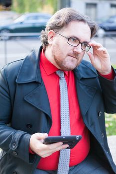 A young businessman with glasses in a urban scene