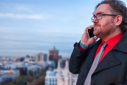 A young businessman with glasses in a urban scene