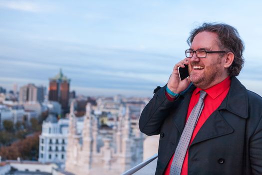 A young businessman with glasses in a urban scene