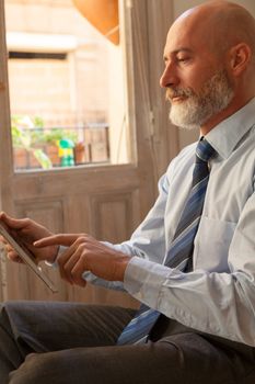 Middle-aged man , handsome and elegant working outside the office in a relaxed and atmosphere