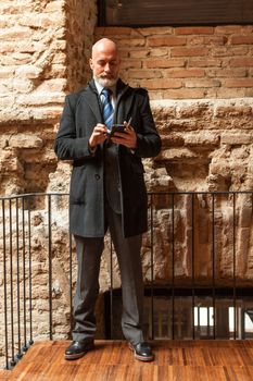 Middle-aged man , handsome and elegant working outside the office in a relaxed atmosphere