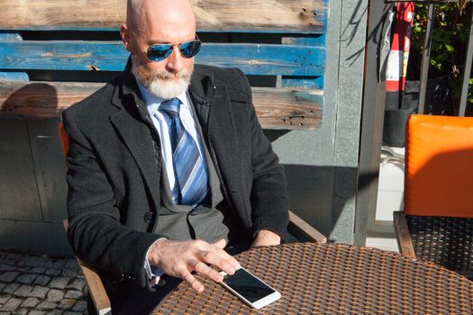 Middle-aged man , handsome and elegant working outside the office in a relaxed atmosphere