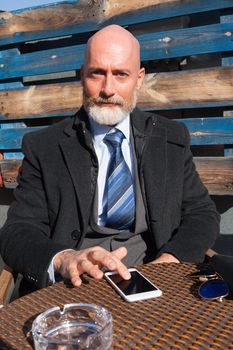 Middle-aged man , handsome and elegant working outside the office in a relaxed atmosphere