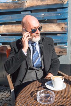 Middle-aged man , handsome and elegant working outside the office in a relaxed atmosphere