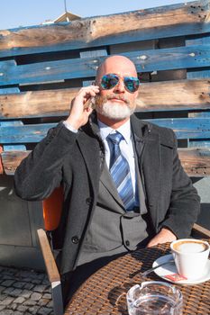 Middle-aged man , handsome and elegant working outside the office in a relaxed atmosphere