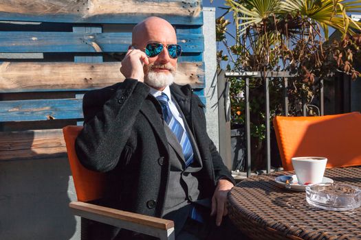 Middle-aged man , handsome and elegant working outside the office in a relaxed atmosphere