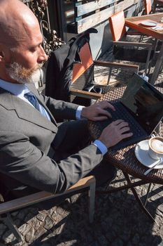 Middle-aged man , handsome and elegant working outside the office in a relaxed atmosphere