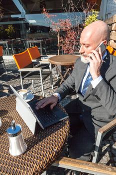 Middle-aged man , handsome and elegant working outside the office in a relaxed atmosphere