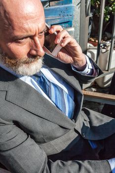 Middle-aged man , handsome and elegant working outside the office in a relaxed and atmosphere