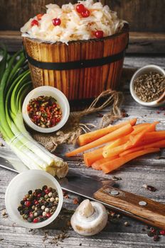 sauerkraut with spices and carrots in a wooden tub