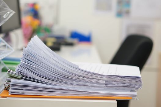 Data of work and supplies were arranged on white desk at office.