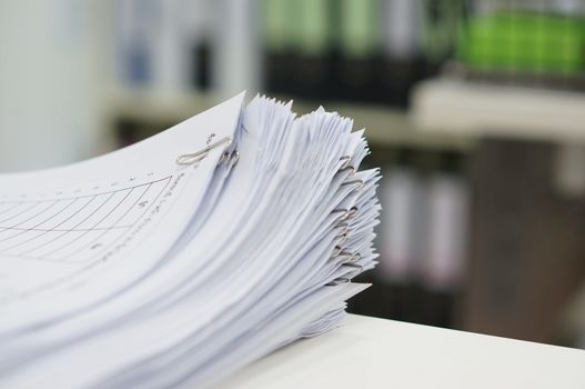 Stack of data test are placed on desk in office.