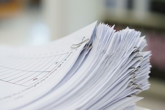 Stack of data test are placed on desk in teacher room.