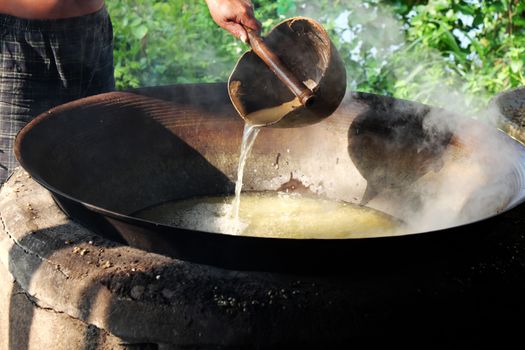 Vietnamese people process mussel, they cook seafood in boil water by firewood, mussel in famous food in Hoian, Vietnam